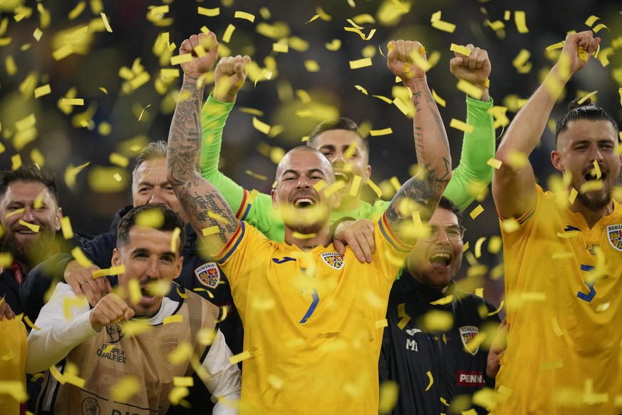 Romania&#039;s Denis Alibec celebrates with team mates after the Euro 2024, group I, qualifying soccer match between Romania and Switzerland at the National Arena stadium in Bucharest, Romania, Tuesda ...