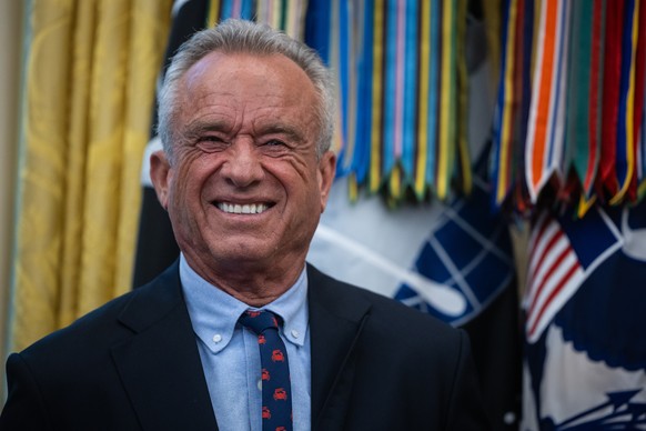 epa12417636 Health and Human Services Secretary Robert F. Kennedy Jr. looks on during the announcement of a drug-pricing deal with Pfizer in the Oval Office at the White House in Washington, DC, USA,  ...