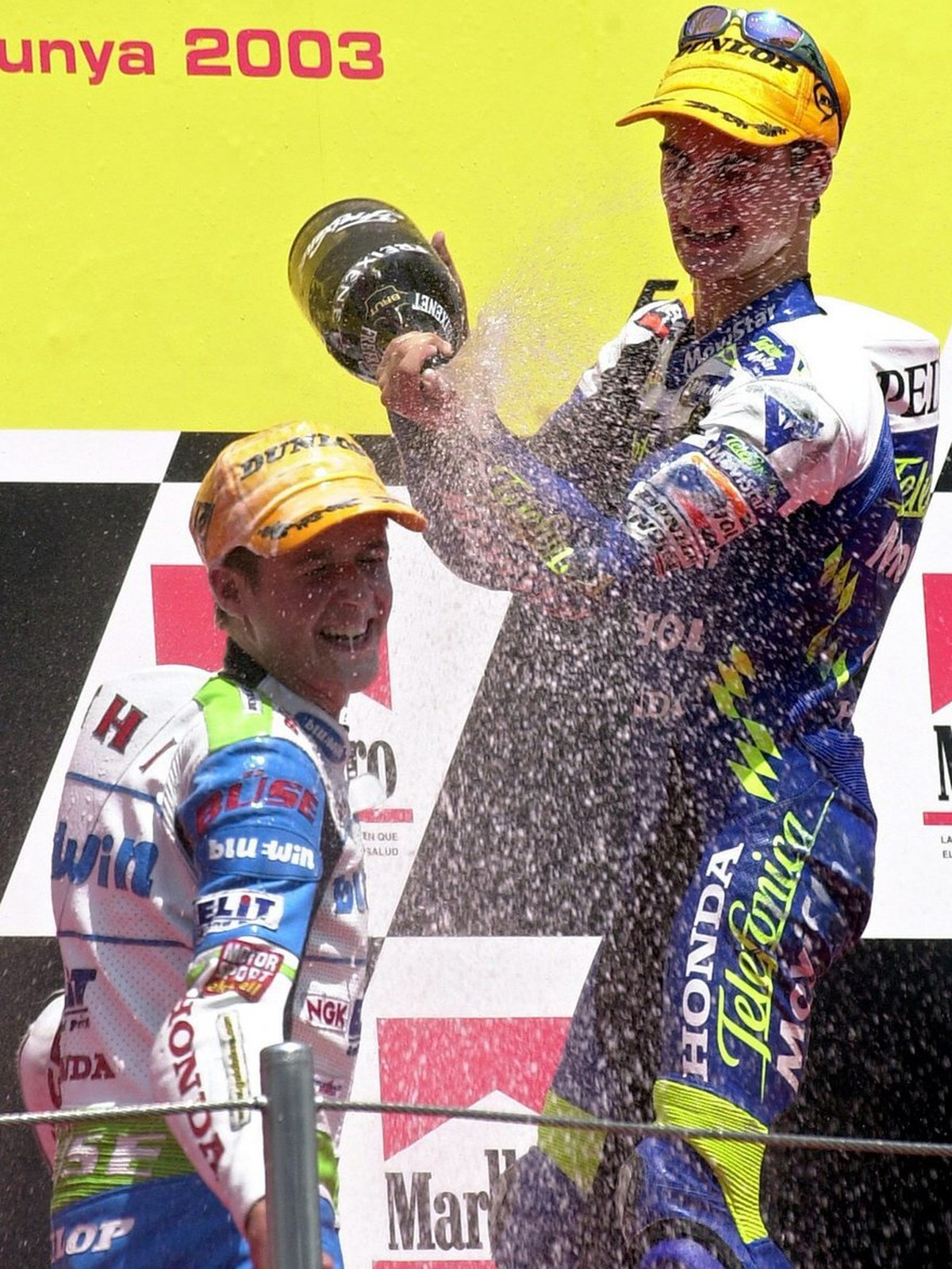 Winner Spanish Daniel Pedrosa (R) celebrates with second placed Swiss Thomas Luethi after winning the 125 cc race of the Catalonian Motorcycle Grand Prix at the Montmelo Circuit in Barcelona, on Sunda ...