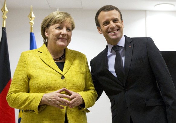 epa06389366 German Chancellor Angela Merkel (L) and French President Emmanuel Macron (R) meet on the sidelines of the European Council meeting in Brussels, Belgium, 14 December 2017. EU leaders will g ...