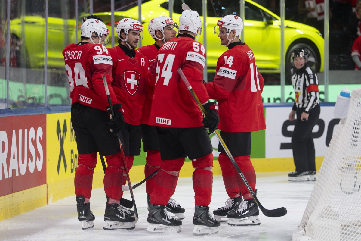 Switzerland's Attilio Bisca, Nico Hischier, Timo Meier, Christian Marti and Dean Kukan, from left, celebrate the score to 2-0 during the 2026 IIHF Men's Ice Hockey World Championship prelimi ...