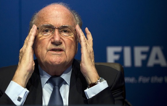 FILE - In this March 30, 2012 file photo FIFA President Sepp Blatter adjusts his glasses during a press conference at the FIFA headquarters in Zurich, Switzerland. Sepp Blatter and Michel Platini have ...