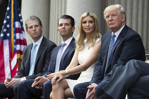 FILE - In this July 23, 2014 file photo, Donald Trump, right, sits with his children, from left, Eric Trump, Donald Trump Jr., and Ivanka Trump during a ground breaking ceremony for the Trump Internat ...