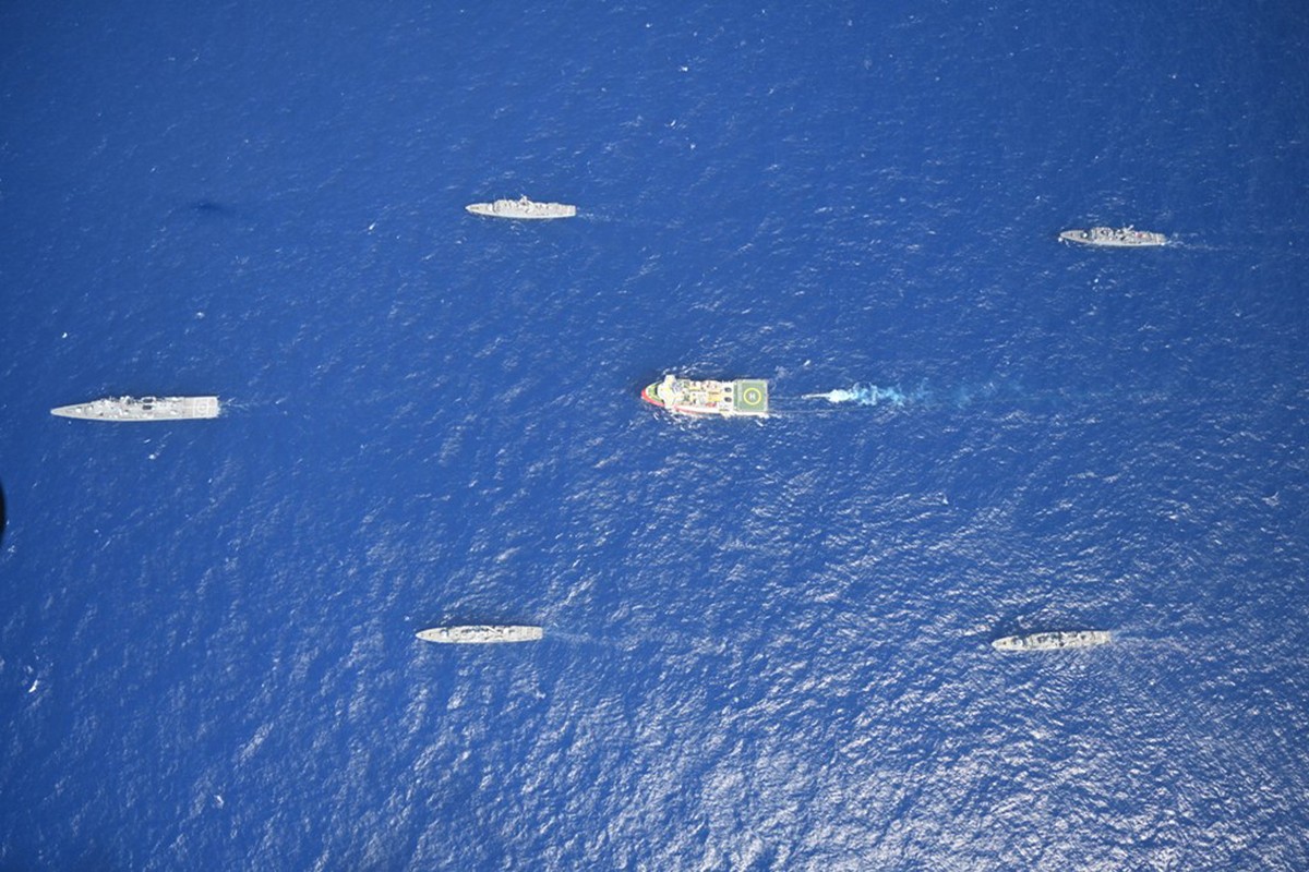 FILE - In this photo provided by the Turkish Defense Ministry on Aug 10, 2020, Turkey's research vessel, Oruc Reis, in red and white, is surrounded by Turkish navy vessels as it was heading in th ...