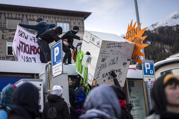Protesters attend a demonstration before the annual meeting of the World Economic Forum, WEF, in Davos, Switzerland, on Sunday January 19, 2025. The World Economic Forum annual meeting brings together ...