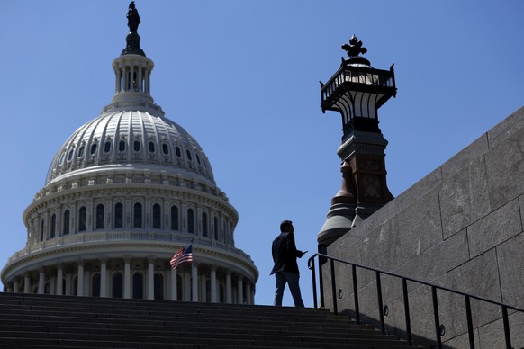 epa13016658 A member of the public walks past the US Capitol in Washington, DC, USA, 04 June 2026. The US Senate is taking part in a vote-a-rama, a rapid series of votes including measures related to  ...
