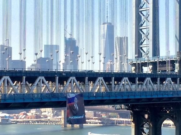 A banner with an image of Russian President Vladimir Putin hangs from the Manhattan Bridge in New York City, U.S., October 6, 2016 in a picture provided by Kathryn Peters. Kathryn Peters/Handout via R ...