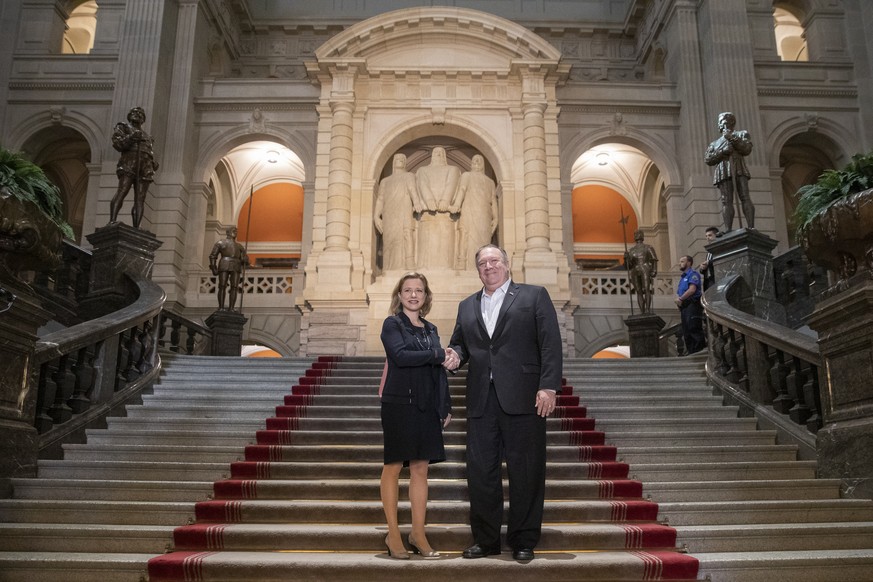 U.S. Secretary of State Mike Pompeo, right, and Christa Markwalder, member of the Swiss National Council, shake hands at the Swiss parliament building, during Pompeo’s visit to Switzerland, on Saturda ...