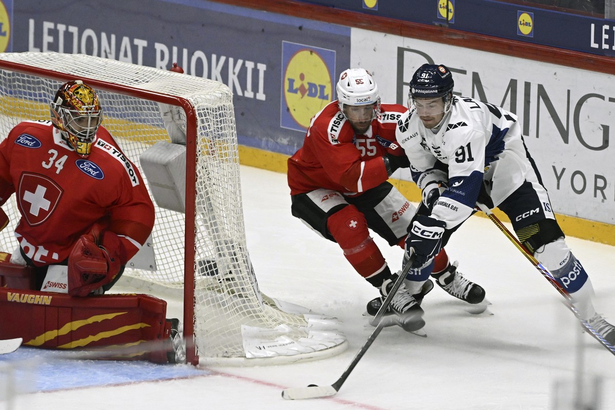 Switzerland's goalkeeper Stephane Charlin and Romain Loeffel (55) defend against Finland's Juho Lammikko (91) during a Euro Hockey Tour Karjala Cup ice hockey match between Switzerland and F ...