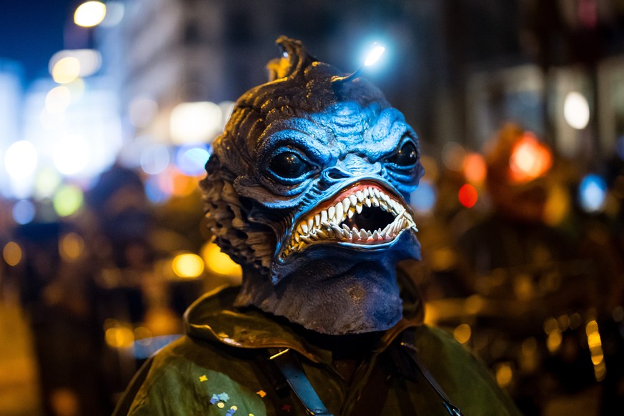 epa11940683 Masked brass and percussion carnival bands parade through the streets during the Monstercorso, the grand finale of the carnival, on Shrove Tuesday in Lucerne, Switzerland, 04 March 2025. E ...