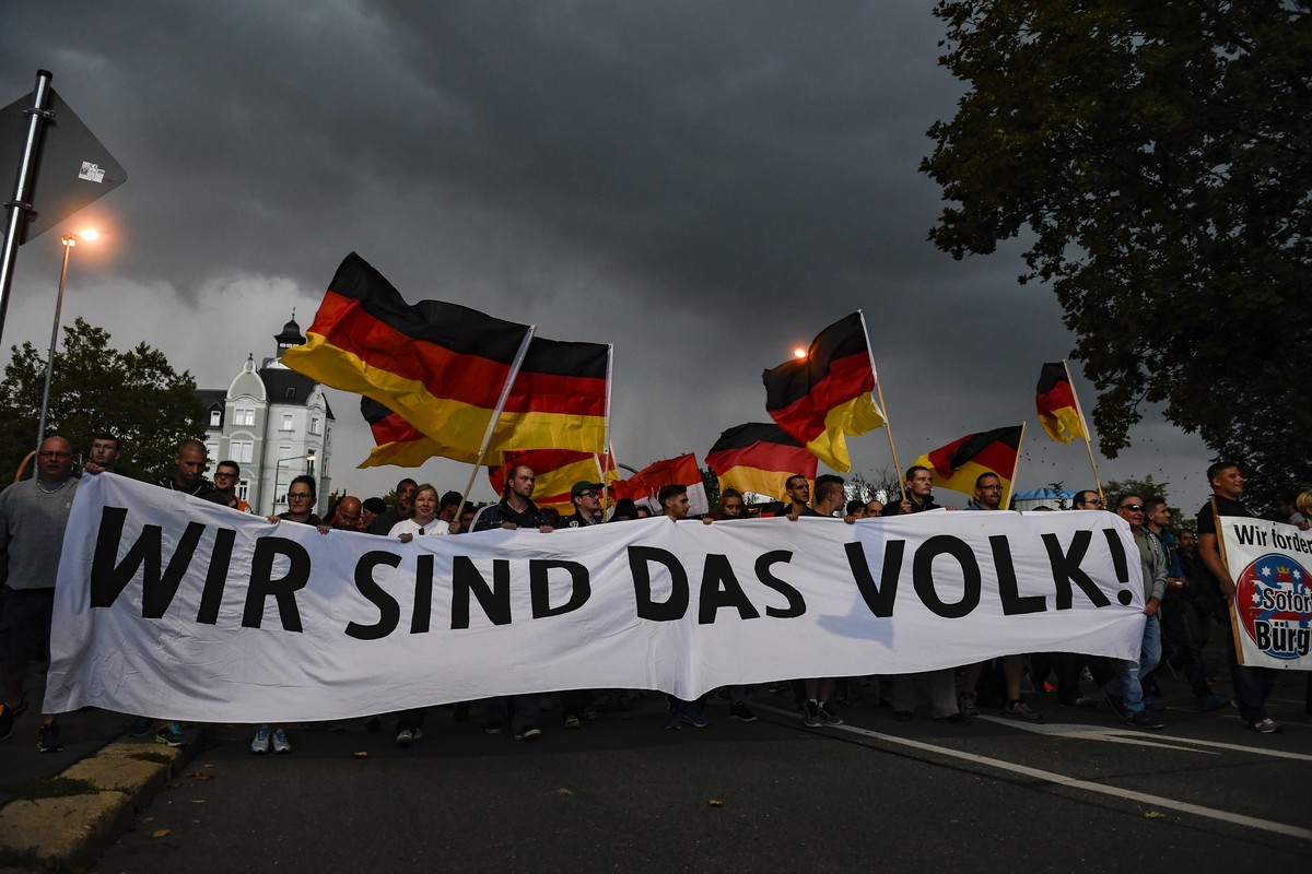 epa07003732 Protesters display a banner reading 'Wir sind das Volk!' (We are the people!) during a rally of right-wing populist movement 'pro Chemnitz' in central Chemnitz, Germany ...