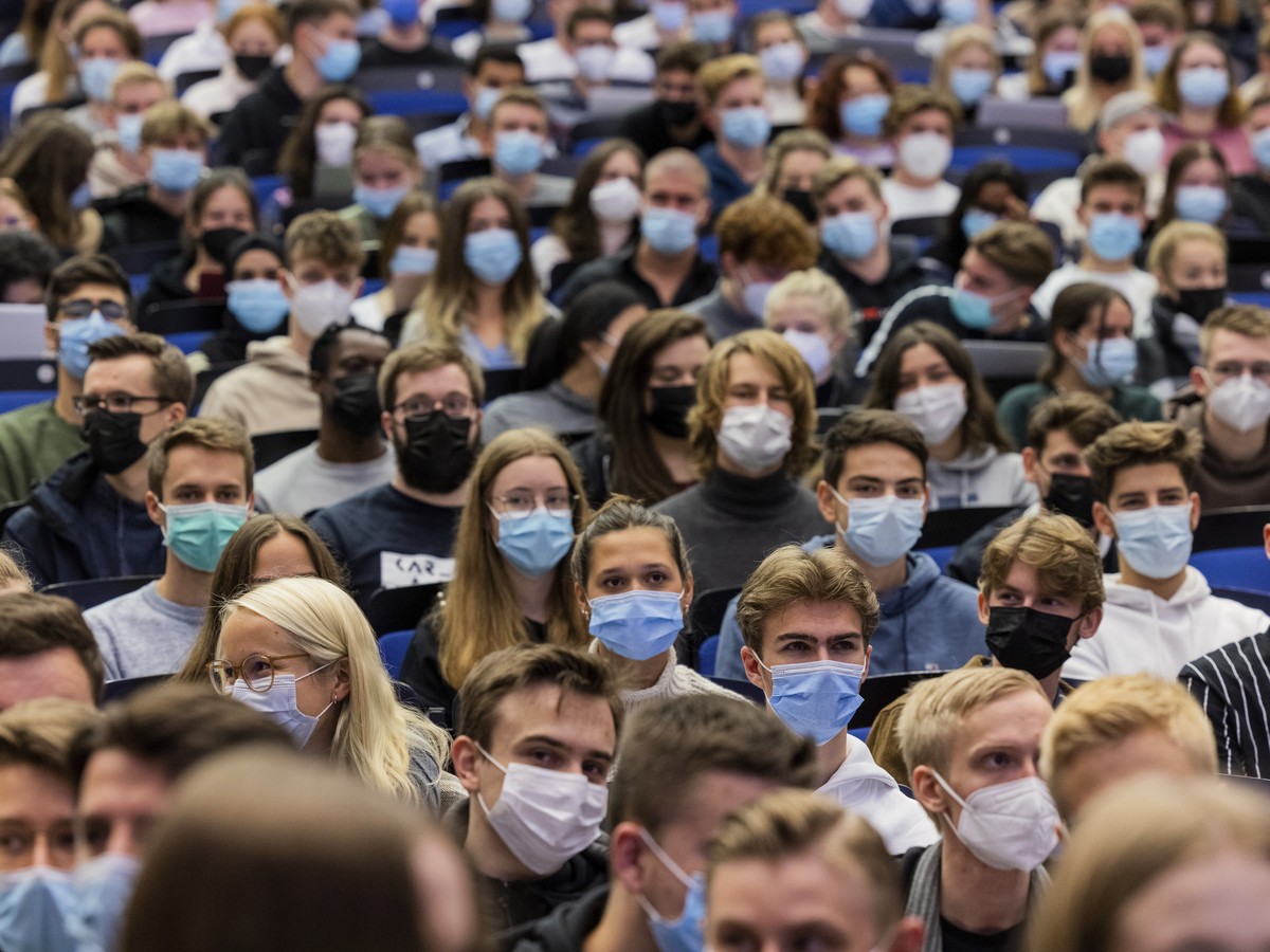 FILE - Students wear mouth-to-nose coverings while sitting close to each other during the lecture "BWL 1" in lecture hall H1 of the Westfaelische Wilhelms-Universitaet in Muenster, Germany,  ...