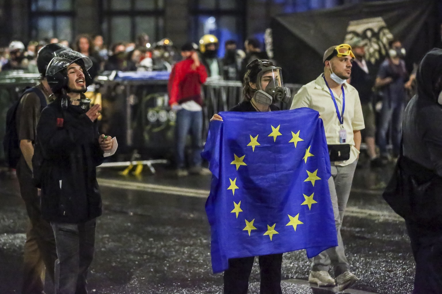 A demonstrator stands with a EU flag in front of police block during an opposition protest against &quot;the Russian law&quot; near the Parliament building in Tbilisi, Georgia, on Wednesday, May 1, 20 ...