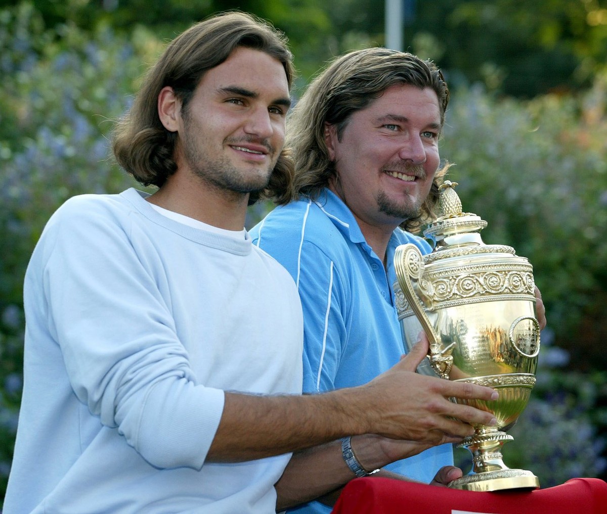 Swiss Roger Federer poses with the Wimbledon trophy during a photocall after winning the Men's Final against Mark Philippoussis of Australia at the All England Lawn Tennis Championships in Wimble ...