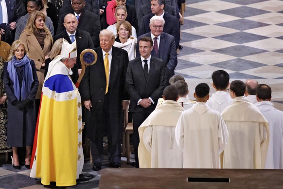 epaselect epa11763434 Paris&#039; Archbishop Laurent Ulrich (2-L), walks past US First Lady Jill Biden (L), US President-elect Donald Trump (3-L) and French President Emmanuel Macron (C) at the end of ...
