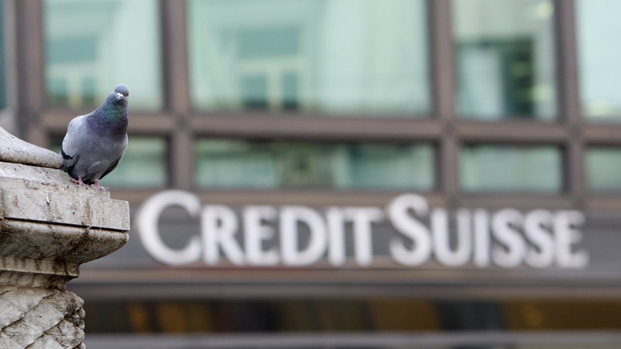 FILE - A pigeon rests near a building hosting offices of Credit Suisse bank in Milan, Tuesday, Oct. 27, 2009. Credit Suisse said Monday, Oct. 17, 2022, that it has agreed to pay $495 million as part o ...
