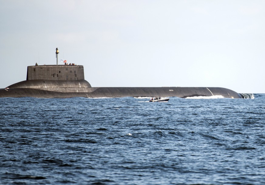 epa06102132 A small motorboat makes its way as the Russian &#039;Thyphoon&#039;-class nuclear submarine &#039;Dmitrij Donskoj&#039; ploughs through Danish waters while reportedly being on its way to S ...