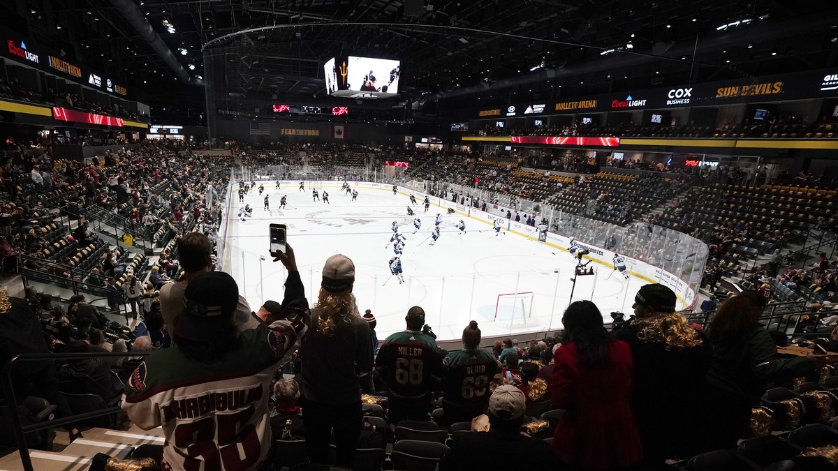 FILE - Fans watch as players warm up prior to the Arizona Coyotes' home-opening NHL hockey game against the Winnipeg Jets at the 5,000-seat Mullett Arena in Tempe, Ariz., Oct. 28, 2022. The Coyot ...