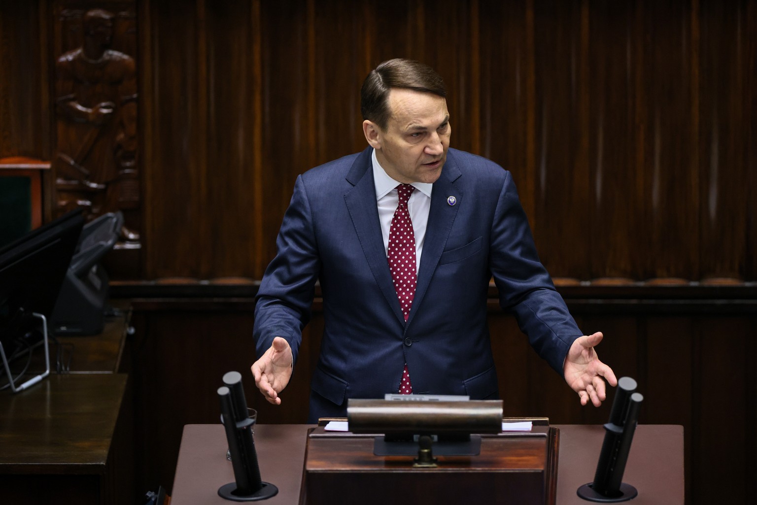 epa11299537 Polish Minister of Foreign Affairs Radoslaw Sikorski gestures during his speech at the Sejm in Warsaw, Poland, 25 April 2024. Minister Sikorski presented information on the tasks of Polish ...