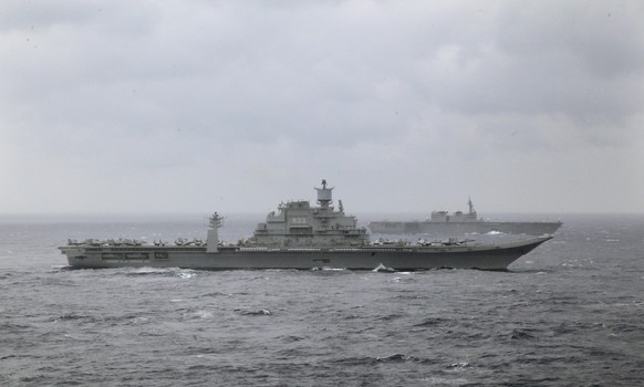 FILE - Indian naval ship INS Vikramaditya, front, participates in the Malabar 2017 tri-lateral exercises between India, Japan and the U.S. in the Bay of Bengal on July 17, 2017. India bought its only aircraft carrier, INS Vikramaditya, from the Soviet Union in 2004. The carrier had served during the former Soviet Union and later for the Russian navy. (AP Photo/Rishi Lekhi, File)