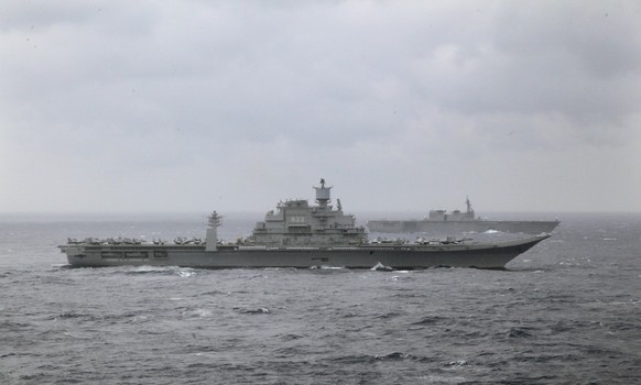 FILE - Indian naval ship INS Vikramaditya, front, participates in the Malabar 2017 tri-lateral exercises between India, Japan and the U.S. in the Bay of Bengal on July 17, 2017. India bought its only  ...