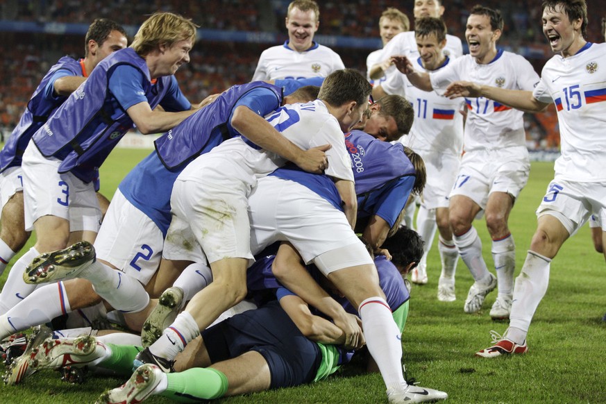 Russia&#039;s Andrei Arshavin, hidden, is celebrated by his teammates after scoring their 3rd goal during the quarterfinal match between the Netherlands and Russia in Basel, Switzerland, Saturday, Jun ...