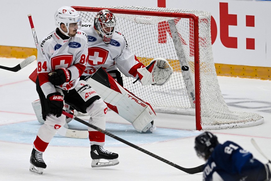 L-R Samuel Kreis and goalkeeper Akira Schmid of Switzerland and scoring Patrik Puistola of Finland during the Switzerland vs Finland match, Czech Hockey Games Betano Hockey Games, final tournament of  ...