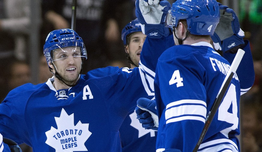 Toronto Maple Leafs defenseman Cody Franson, right, is congratulated by teammate Jay McClement after scoring against the Detroit Red Wings during first-period NHL hockey game action in Toronto, Saturd ...