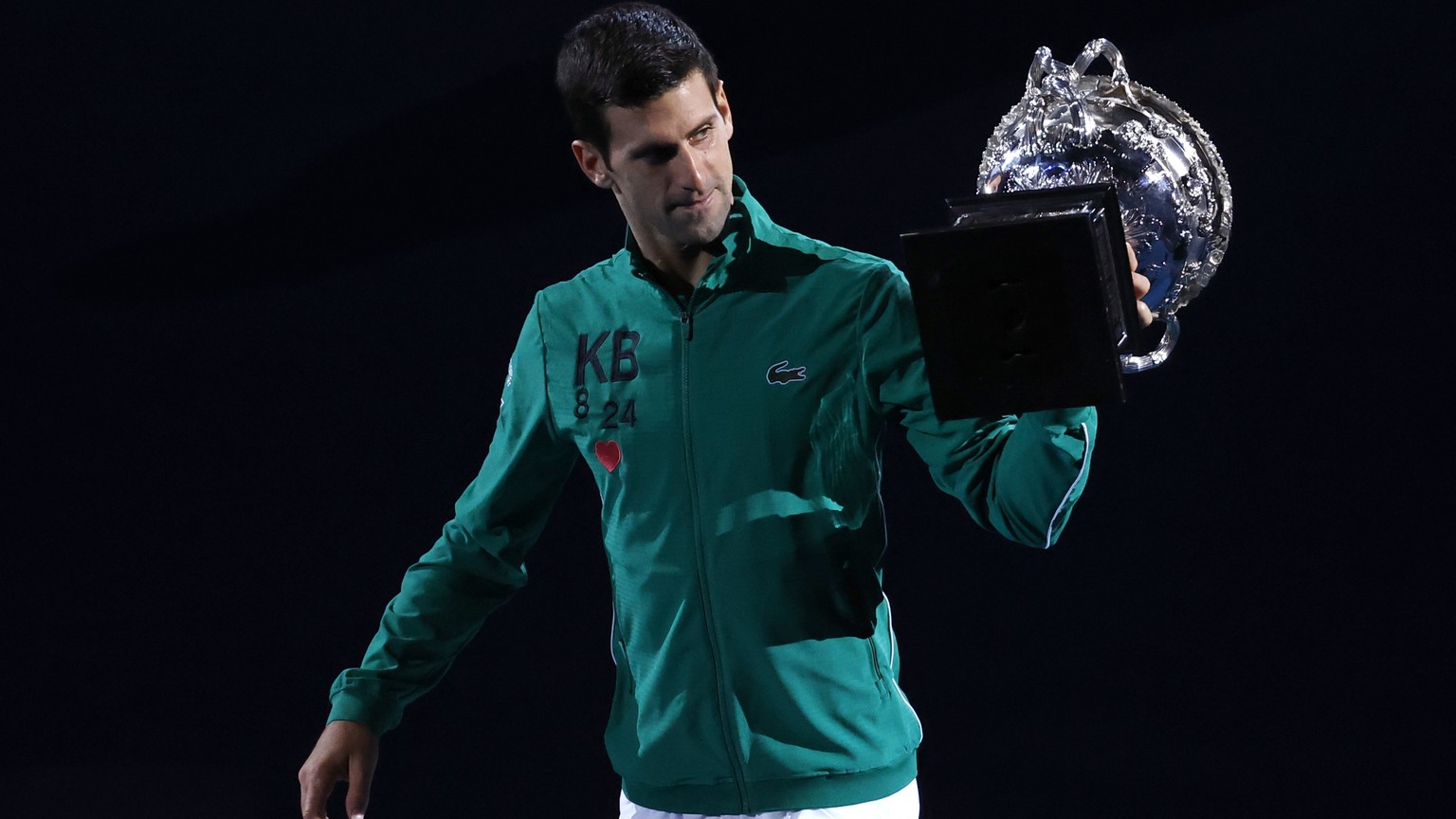 Serbia&#039;s Novak Djokovic carries the Norman Brookes Challenge Cup around Rod Laver Arena after defeating Austria&#039;s Dominic Thiem in the men&#039;s singles final of the Australian Open tennis  ...