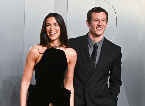 FILE - Dua Lipa, left, and Callum Turner arrive at the Vanity Fair Oscar Party on Sunday, March 15, 2026, at the Los Angeles County Museum of Art in Los Angeles. (Photo by Evan Agostini/Invision/AP, F ...