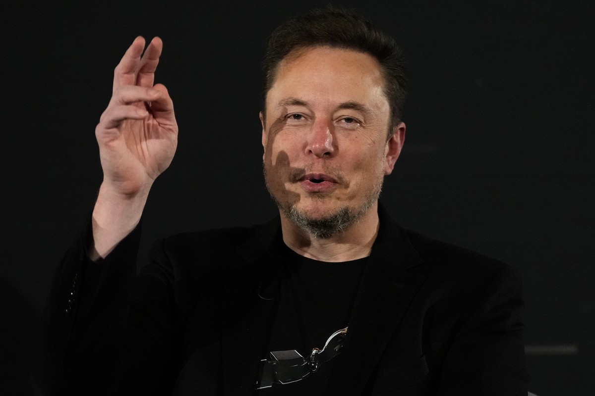 FILE - Elon Musk, owner of social media platform X, gestures during an event with Britain's Prime Minister Rishi Sunak in London on Nov. 2, 2023. The world could have its first trillionaire withi ...