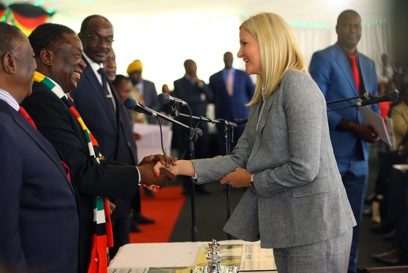 epa07010787 Zimbabwean Olympic gold medallist swimmer Kirtsy Coventry (2-R) is congratulated by Zimbabwean President Emmerson Mnangagwa (2-L) after taking the oath of office to be sworn in as the Mini ...