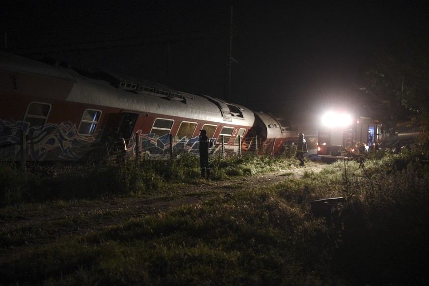 Rescuers search the site of a fatal train derailment close to the northern city of Thessaloniki, Greece on Sunday, May 14, 2017. The train was traveling on the Athens-Thessaloniki route when it went o ...