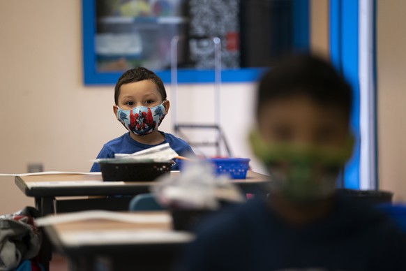 Nathan Ramos sits in a kindergarten classroom on the first day of in-person learning at Maurice Sendak Elementary School in Los Angeles, Tuesday, April 13, 2021. More than a year after the pandemic fo ...