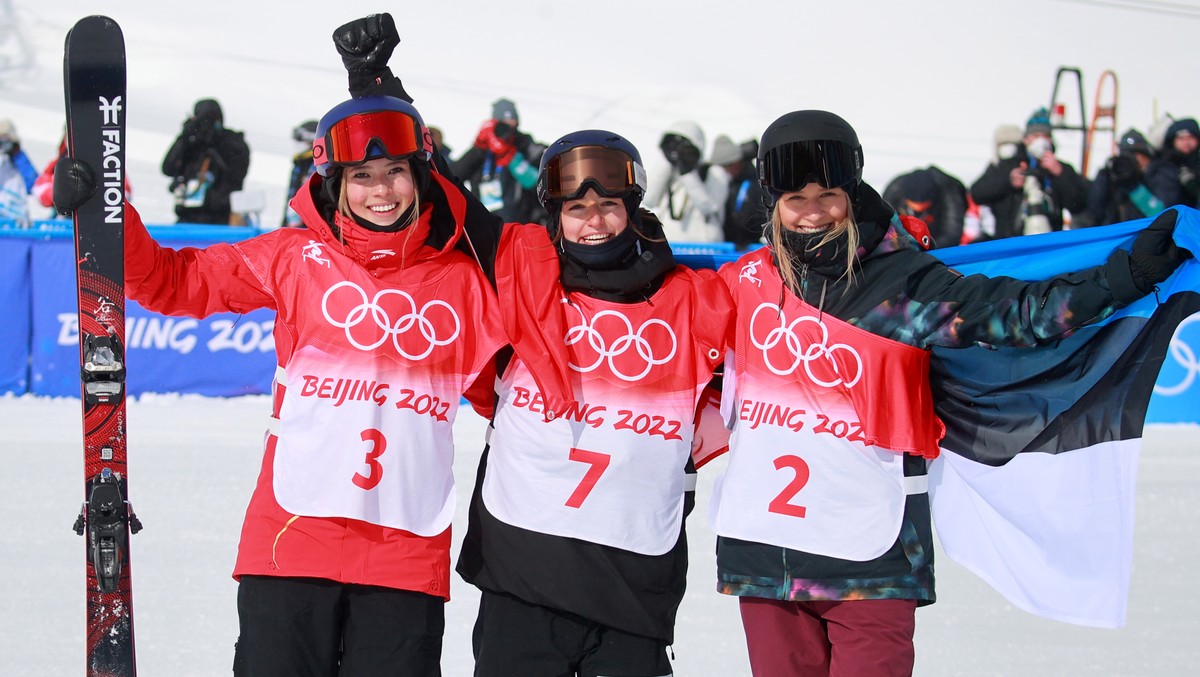 epa09757299 (L-R) Silver medalist Ailing Eileen Gu of China, gold medalist Mathilde Gremaud of Switzerland and bronze Kelly Sildaru of Estonia celebate during Women's Freestyle Skiing Slopestyle  ...