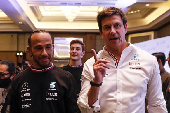 epa10211104 Team Principal and CEO of Mercedes-AMG Petronas F1 team Toto Wolff (R) walking with his driver, British driver Lewis Hamilton (L) and British driver George Russell (C) after press conferen ...