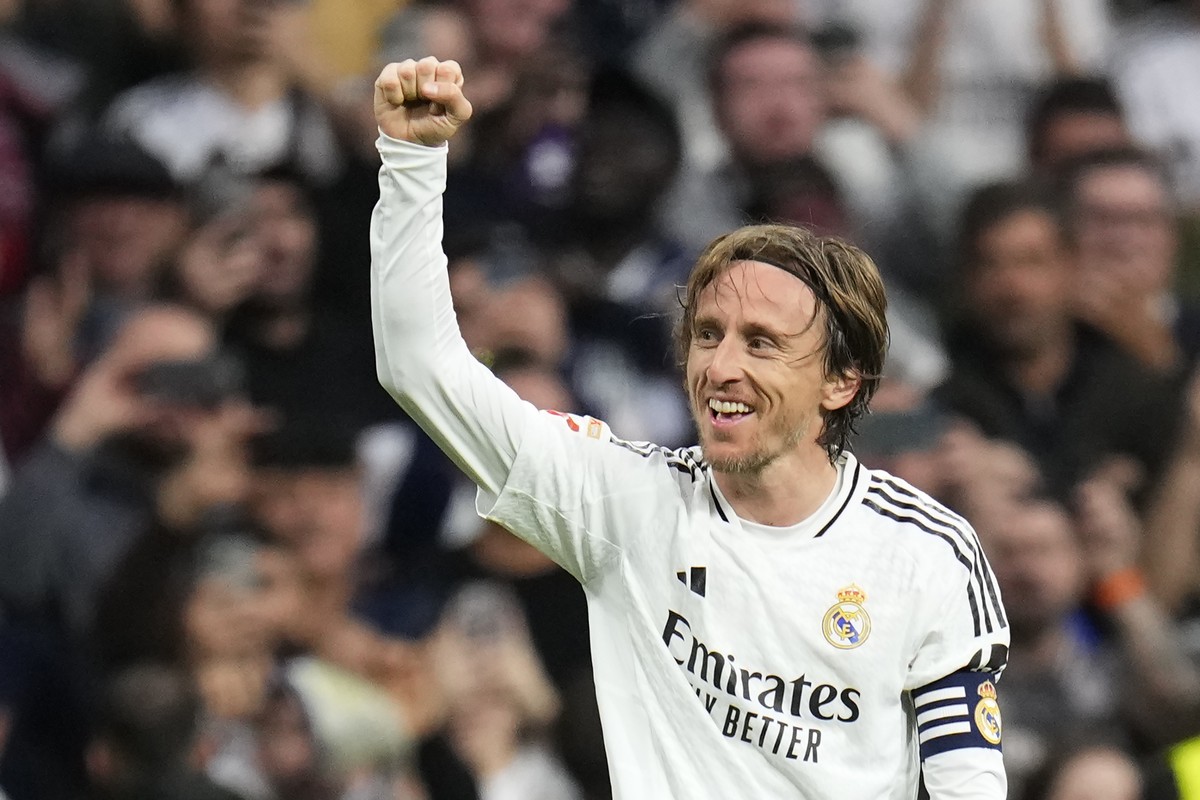 Real Madrid's Luka Modric celebrates after scoring the opening goal during the Spanish La Liga soccer match between Real Madrid and Girona at the Santiago Bernabeu stadium in Madrid, Spain, Sunda ...