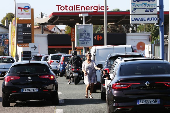 Drivers wait to fill their gas tank in a station in Anglet, southwestern France, Tuesday, Oct. 18, 2022. France is in the grip of transport strikes and protests for salary raise on Tuesday that threat ...
