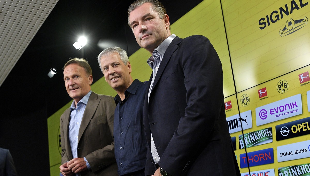 epa06867677 Swiss Lucien Favre (C), the newly appointed head coach of German Bundesliga team Borussia Dortmund, Dortmund's director of sports Michael Zorc (R) and Dortmund's CEO Hans-Joachim ...