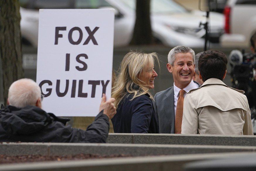 A protester holds a sign at Fox News representatives outside the courthouse for the Dominion Voting Systems defamation lawsuit against Fox News, Tuesday, April 18, 2023, in Wilmington,…