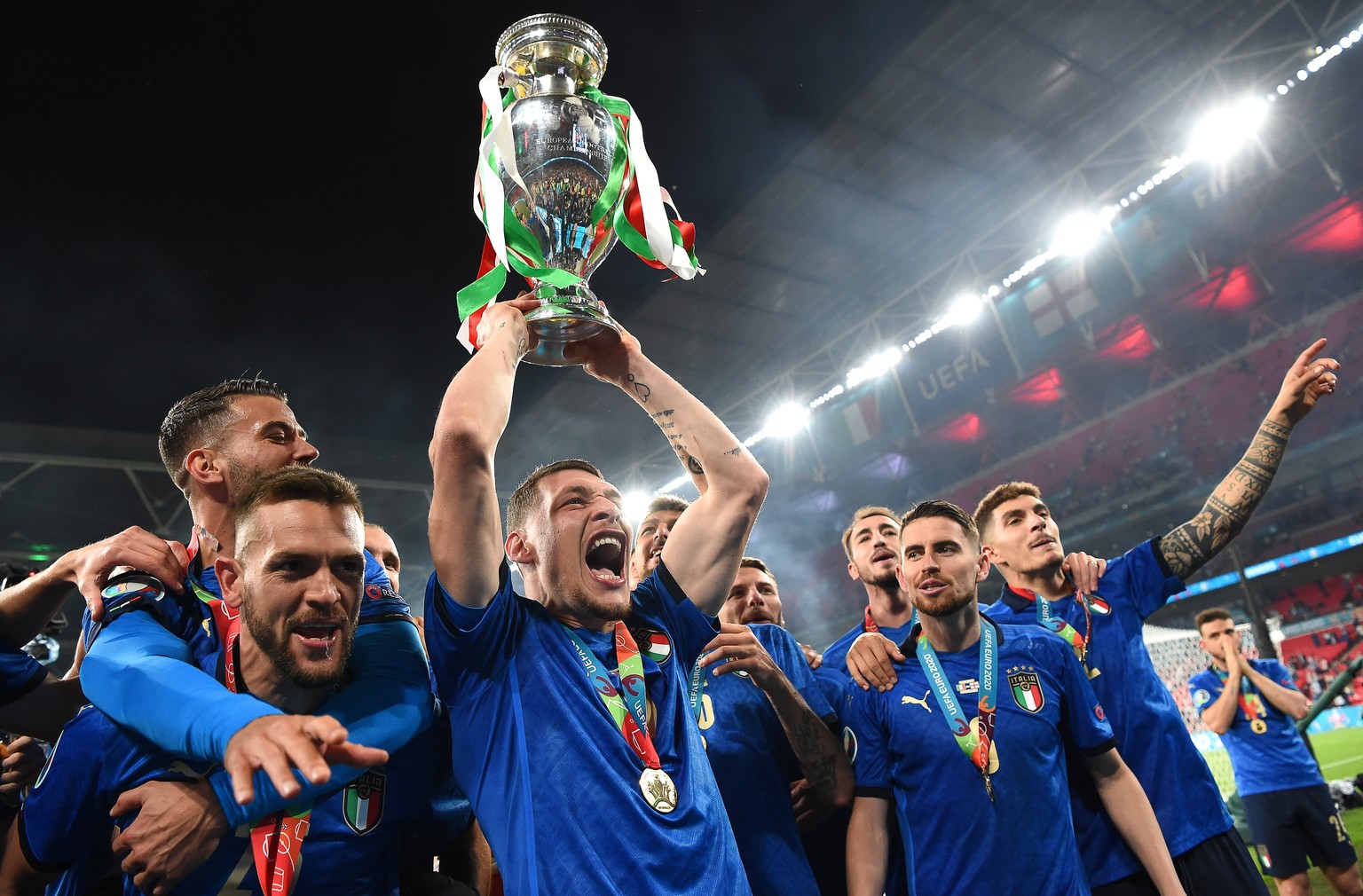 epa09339024 Andrea Belotti (C) of Italy lifts the trophy as his teammates celebrate after winning the UEFA EURO 2020 final between Italy and England in London, Britain, 11 July 2021. EPA/Andy Rain / P ...
