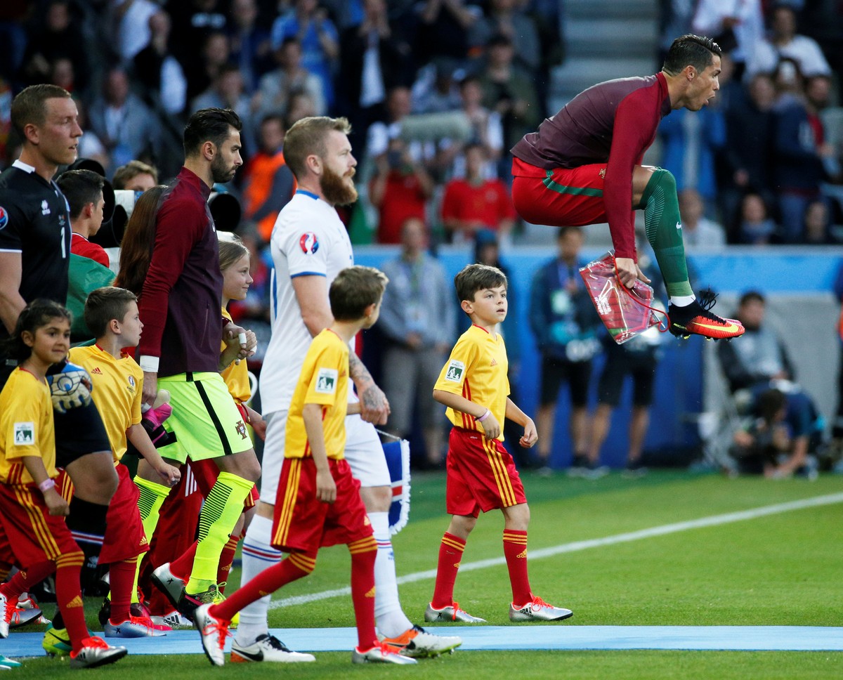 Football Soccer - Portugal v Iceland - EURO 2016 - Group F - Stade Geoffroy-Guichard, Saint-Étienne, France - 14/6/16Portugal's Cristiano Ronaldo jumps as he leads his team out before the gameREU ...