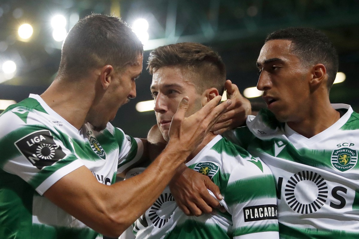 Sporting's Luciano Vietto is congratulated by teammates Zouhair Feddal Agharbi, left, and Tiago Tomas, right, after scoring his side's second goal during the Portuguese league soccer match b ...
