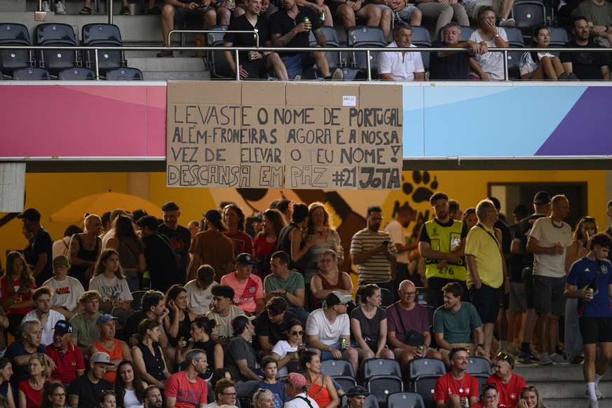 epa12213812 Fans display a sign in memory of the late Portuguese soccer player Diogo Jota, who lost his life in a car crash in Spain on 03 July, ahead of the UEFA Women&#039;s EURO 2025 Group B soccer ...