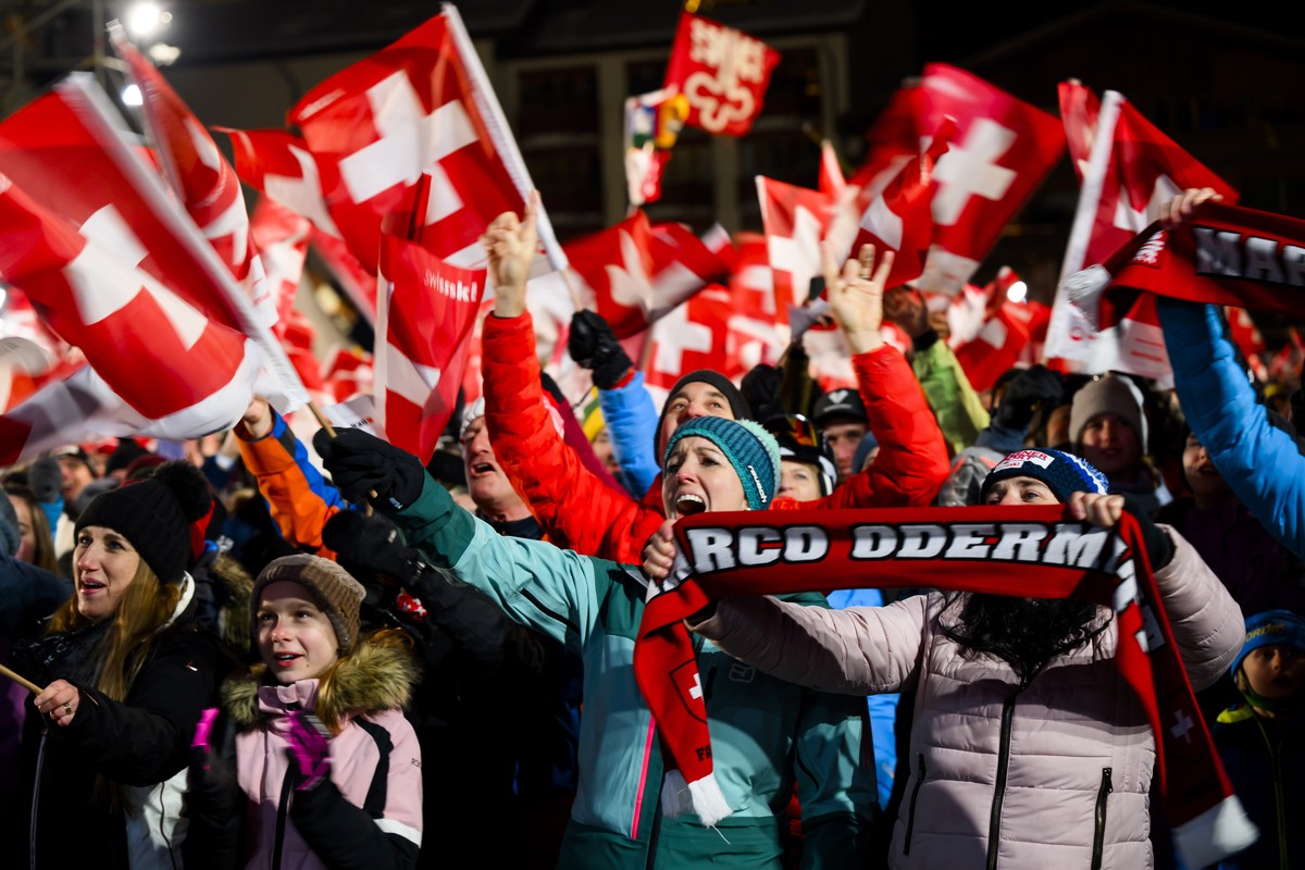 Spectators celebrate for the winner Marco Odermatt of Switzerland during the Awards ceremony of the men's downhill race at the Alpine Skiing FIS Ski World Cup in Wengen, Switzerland, Saturday, Ja ...