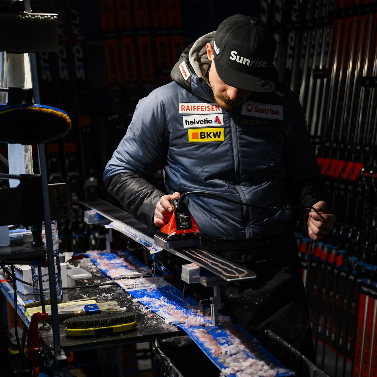 Simon Vicenzi, a Swiss-ski service technician, uses an iron to melt wax on a ski during ski preparation for an athlete using the Stoeckli brand at the Alpine Skiing FIS Ski World Cup, in St. Moritz, S ...