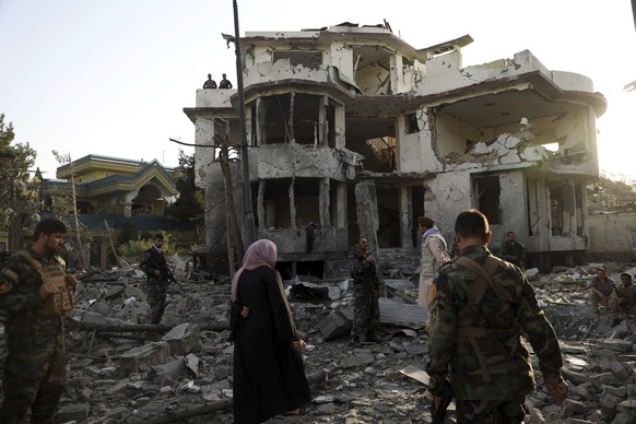 Afghan security personnel inspect a damaged building in the aftermath of an attack in Kabul, Afghanistan, Wednesday, Aug. 4, 2021. A powerful explosion rocked an upscale neighborhood of Afghanistan&#0 ...