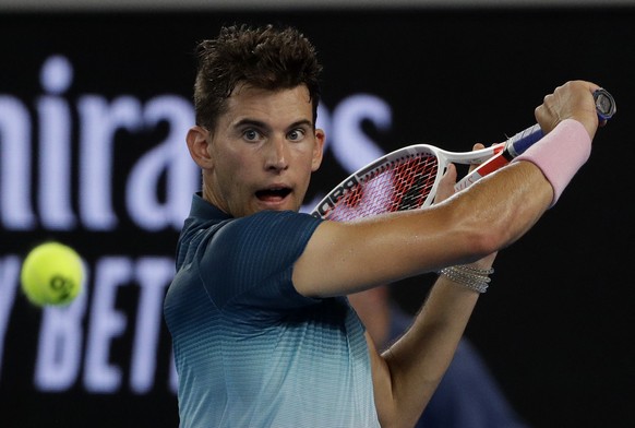 Austria&#039;s Dominic Thiem makes a backhand return to France&#039;s Benoit Paire during their first round match at the Australian Open tennis championships in Melbourne, Australia, Tuesday, Jan. 15, ...