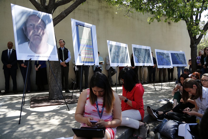 epa06693046 A mug shot on an easel stand of the suspect identified as Joseph James DeAngelo, 72, a former police officer in Visalia and Auburn, California (L) and lists of victim and maps throughout N ...