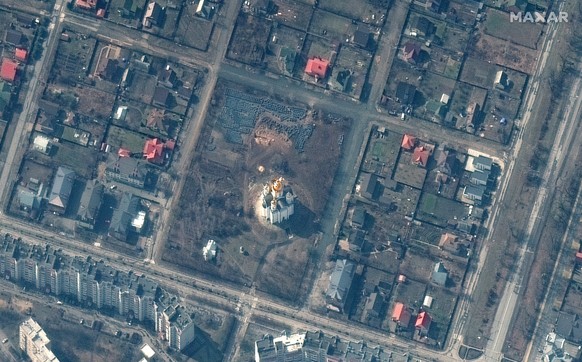 This satellite image provided by Maxar Technologies shows an overview of Bucha, Ukraine, with the church of St. Andrew at center and the site of a probable mass grave just above that on Thursday March ...